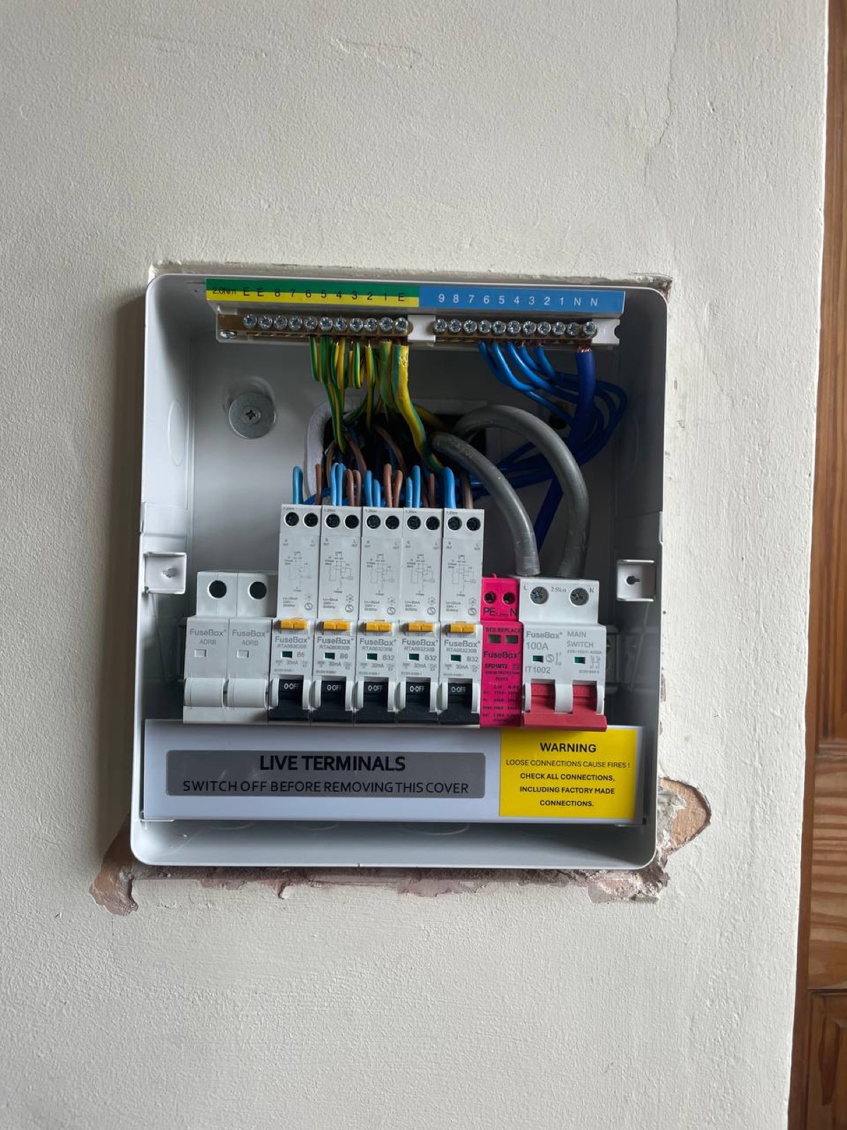 FuseBox distribution board interior showing MCBs and terminals during installation and testing